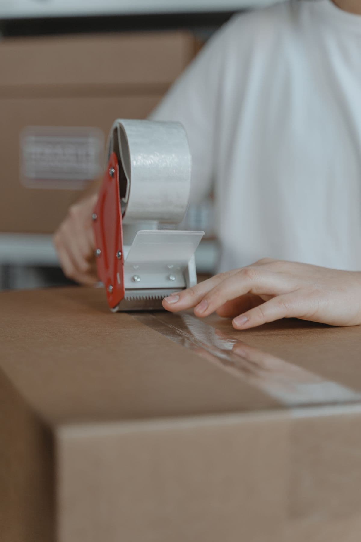A team member sealing a completed order for shipment